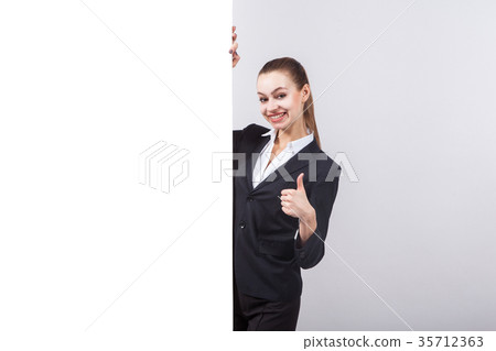 girl in a business suit stands next to the board 35712363