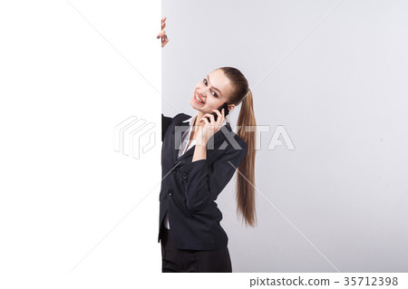 Young business woman in a business suit stands 35712398