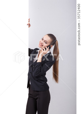 Young business woman in a business suit stands 35712400