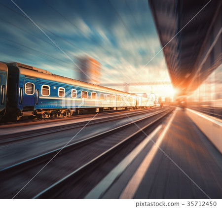 Beautiful train with blue wagons in motion 35712450
