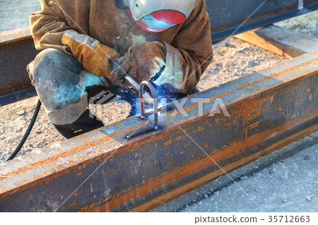 Worker welding in a factory.  35712663