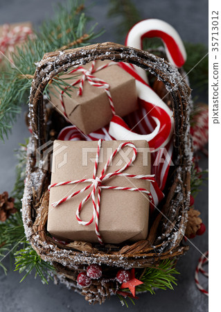 Christmas wicker basket with gifts or present boxes 35713012