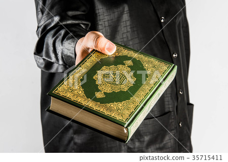 Koran in hand ,Quran in hand - holy book of Muslim Koran in hand ,Quran in hand - holy book of Muslim 35715411