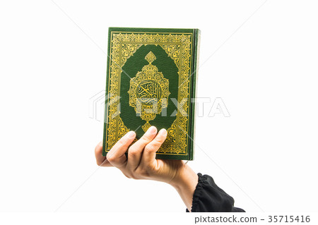Koran in hand ,Quran in hand - holy book of Muslim Koran in hand ,Quran in hand - holy book of Muslim 35715416