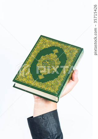 Koran in hand ,Quran in hand - holy book of Muslim Koran in hand ,Quran in hand - holy book of Muslim 35715426