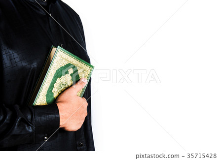 Koran in hand ,Quran in hand - holy book of Muslim Koran in hand ,Quran in hand - holy book of Muslim 35715428
