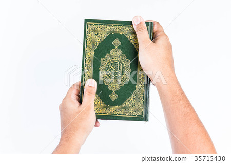 Koran in hand ,Quran in hand - holy book of Muslim Koran in hand ,Quran in hand - holy book of Muslim 35715430