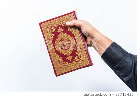 Koran in hand ,Quran in hand - holy book of Muslim Koran in hand ,Quran in hand - holy book of Muslim 35715435