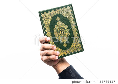 Koran in hand ,Quran in hand - holy book of Muslim Koran in hand ,Quran in hand - holy book of Muslim 35715437