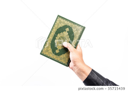 Koran in hand ,Quran in hand - holy book of Muslim Koran in hand ,Quran in hand - holy book of Muslim 35715439