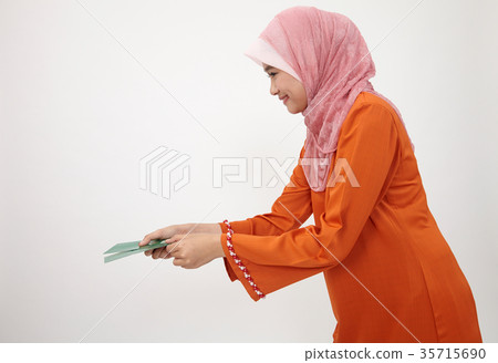 malay girl with tudung with green envelope 35715690