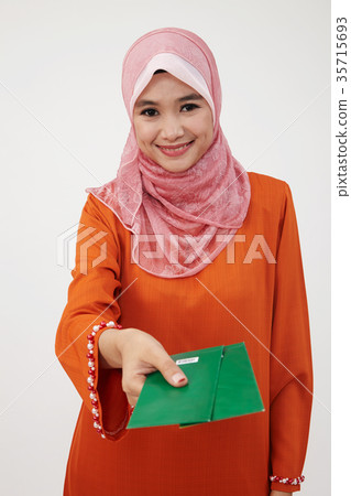 malay girl with tudung with green envelope 35715693
