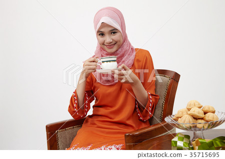 malay girl with tudung holding cup of hot tea 35715695