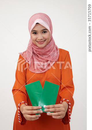 malay girl with tudung with green envelope malay girl with tudung with green envelope 35715709
