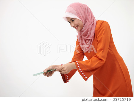 malay girl with tudung with green envelope 35715719