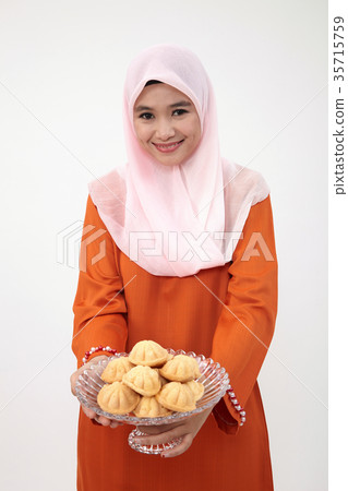malay girl with tudung with kueh bahulu 35715759