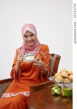 malay girl with tudung holding cup of hot tea 35715774