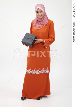 malay girl with tudung holding gift box 35715778