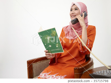 malay girl with tudung talking with land line phone 35715798