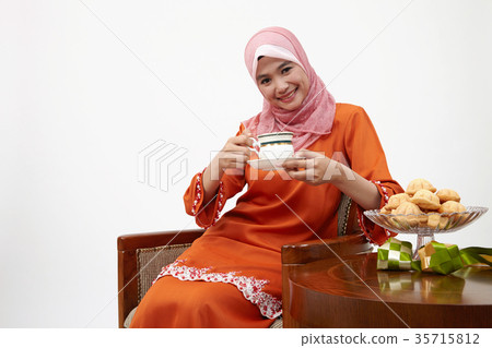 malay girl with tudung holding cup of hot tea 35715812
