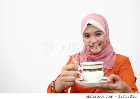 malay girl with tudung holding cup of hot tea 35715816
