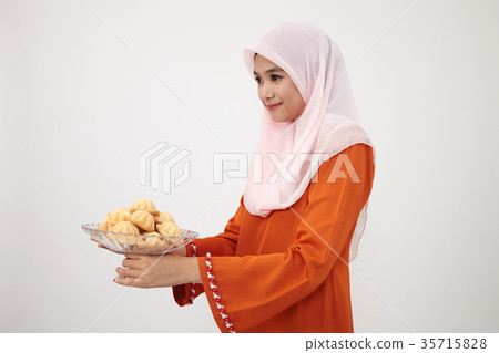 malay girl with tudung with kueh bahulu 35715828
