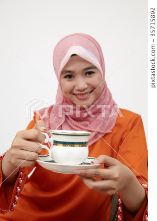 malay girl with tudung holding cup of hot tea 35715892