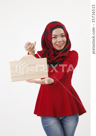 malay woman holding wooden signage 35716515