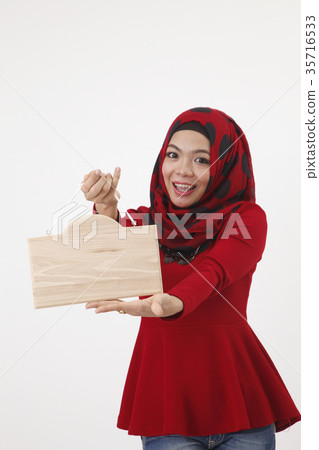 malay woman holding wooden signage 35716533