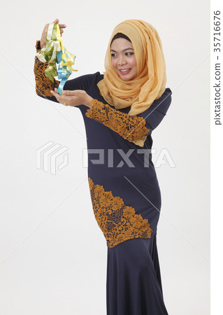 malay woman showing ketupat 35716676