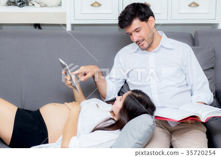 Asian couple family young mother using a tablet Asian couple family young mother using a tablet 35720254