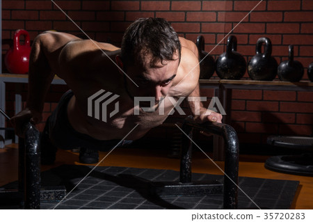 Cute muscular man peeking in the gym Cute muscular man peeking in the gym 35720283
