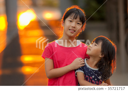 Children sister playing in the park in the evening Children sister playing in the park in the evening 35721717