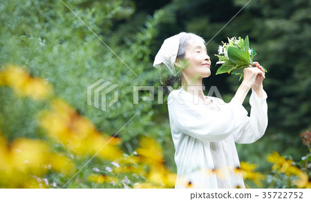 Senior woman smelling the smell of flowers 35722752