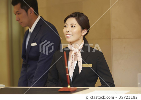 Men and women working in a hotel reception Men and women working in a hotel reception 35723182