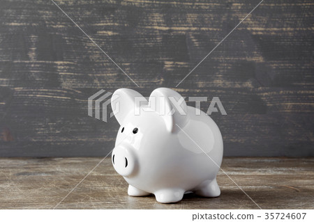 Piggy bank on wooden background 35724607