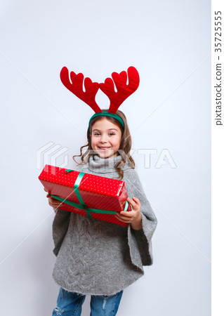Happy little smiling girl with christmas gift box Happy little smiling girl with christmas gift box 35725555