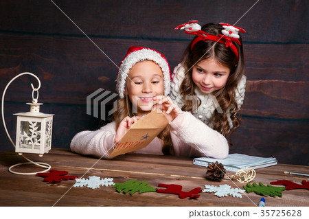 child writes letter to Santa Claus . Funny girls 35725628
