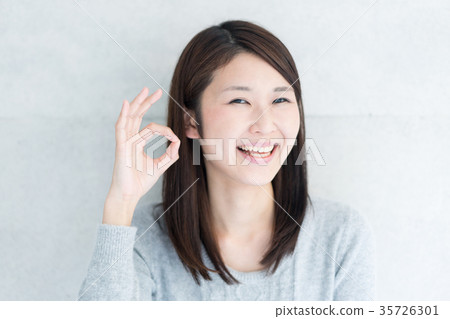A woman giving an OK signal 35726301