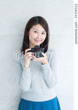 A woman taking a picture 35726312