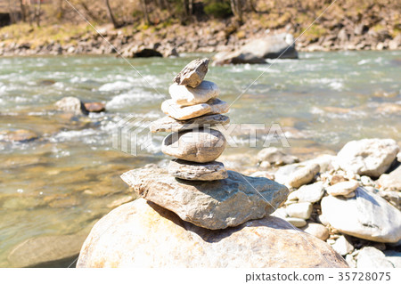 Balanced stone pyramid blue water  Mountain River. 35728075