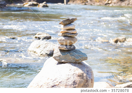 Balanced stone pyramid blue water Mountain River. Balanced stone pyramid blue water Mountain River. 35728078