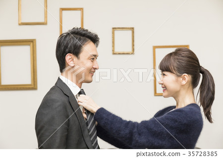 Businessman before going to work, image of a loving couple Businessman before going to work, image of a loving couple 35728385