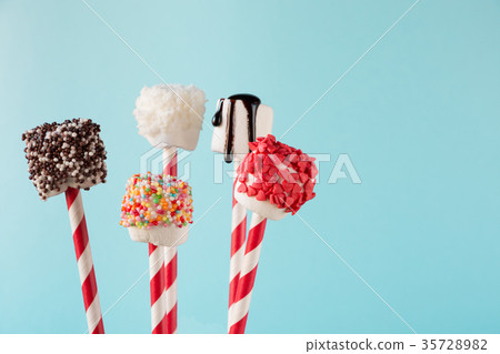 Sweet chewy marshmallow on straw with decor. Sweet chewy marshmallow on straw with decor. 35728982
