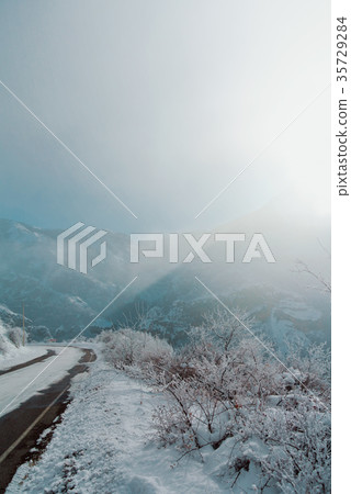 A dangerous winter serpentine road with attention 35729284