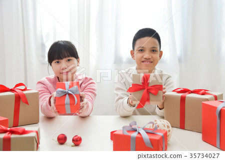 Happy Asian boy and girl holding a gift boxes. 35734027