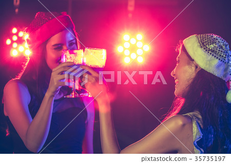 Beautiful girls having fun at a party. Beautiful girls having fun at a party. 35735197