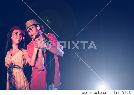 Young couple having fun dancing at a party. Young couple having fun dancing at a party. 35735198