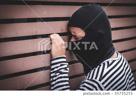 Robber hiding behind the wall Robber hiding behind the wall 35735255