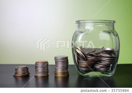 Stack of money - Coin in glass jar Stack of money - Coin in glass jar 35735984